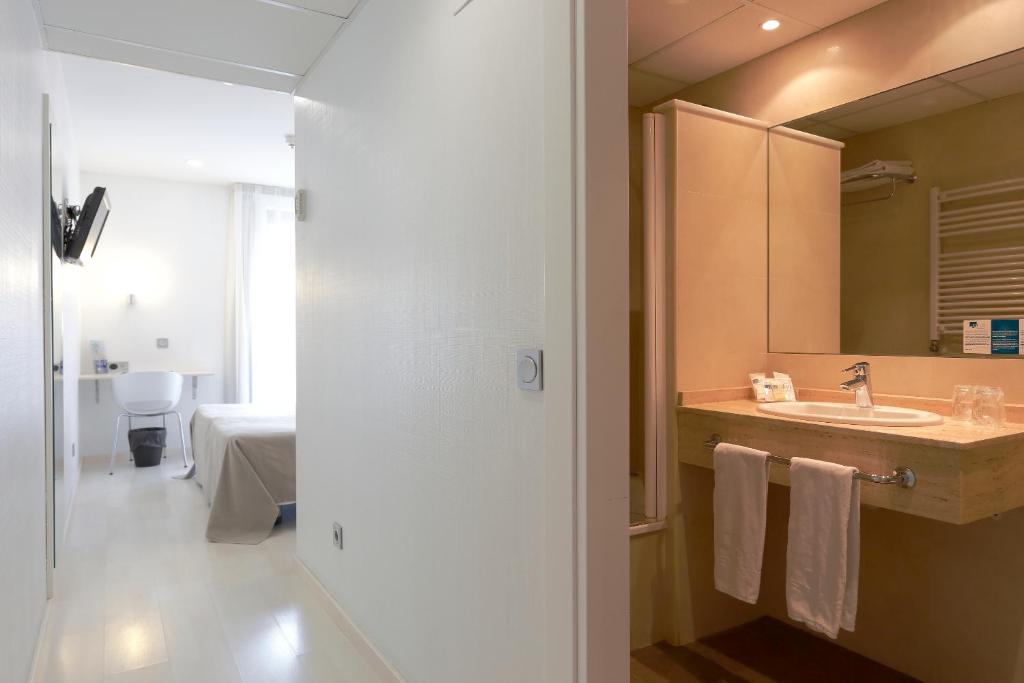 a bathroom with a sink and a mirror at Hotel Santa Rosa, Blue Hoteles in Gijón
