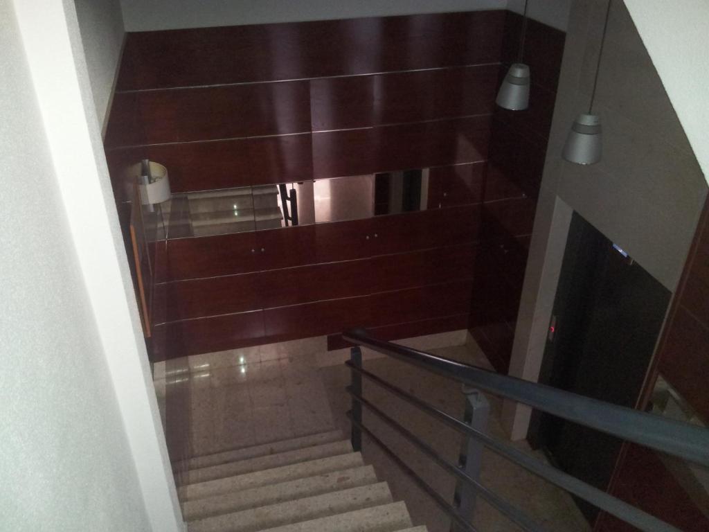 a stairway with wooden walls and wooden stairs at Apartamentos Aixa in Caravaca de la Cruz