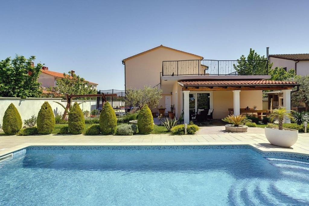 a swimming pool in front of a house at Villa Iva in Medulin