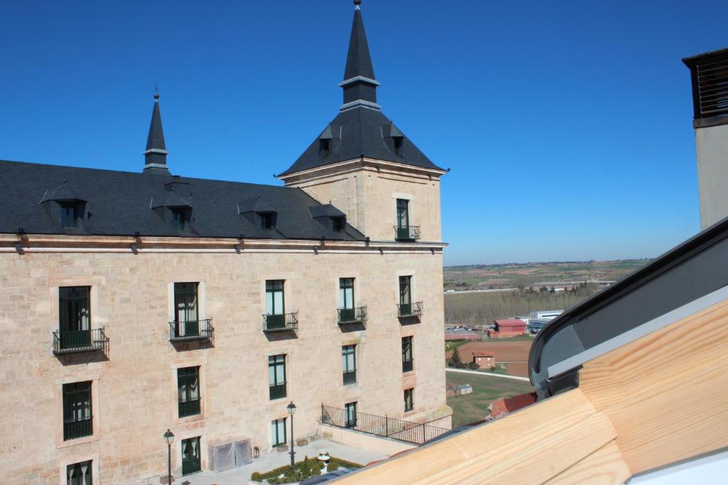 a large brick building with two towers on top of it at Ático Vista Alegre in Lerma