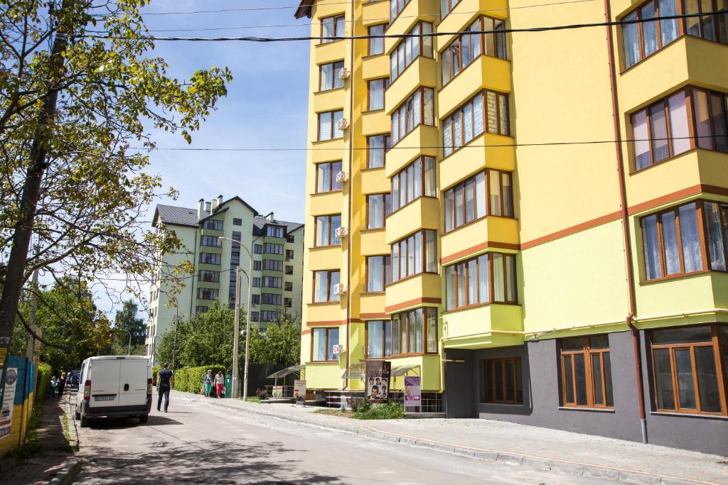 a yellow building on the side of a street at Apartment on Shashkevicha 16 in Truskavets