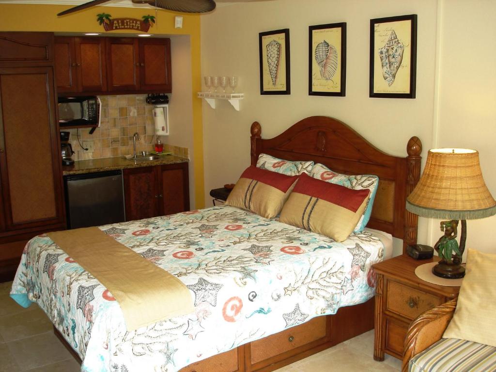 a bedroom with a bed and a table with a lamp at Islander on the Beach Unit 244 in Kapaa