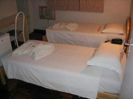 Postel nebo postele na pokoji v ubytování Hotel Topazio Ltda