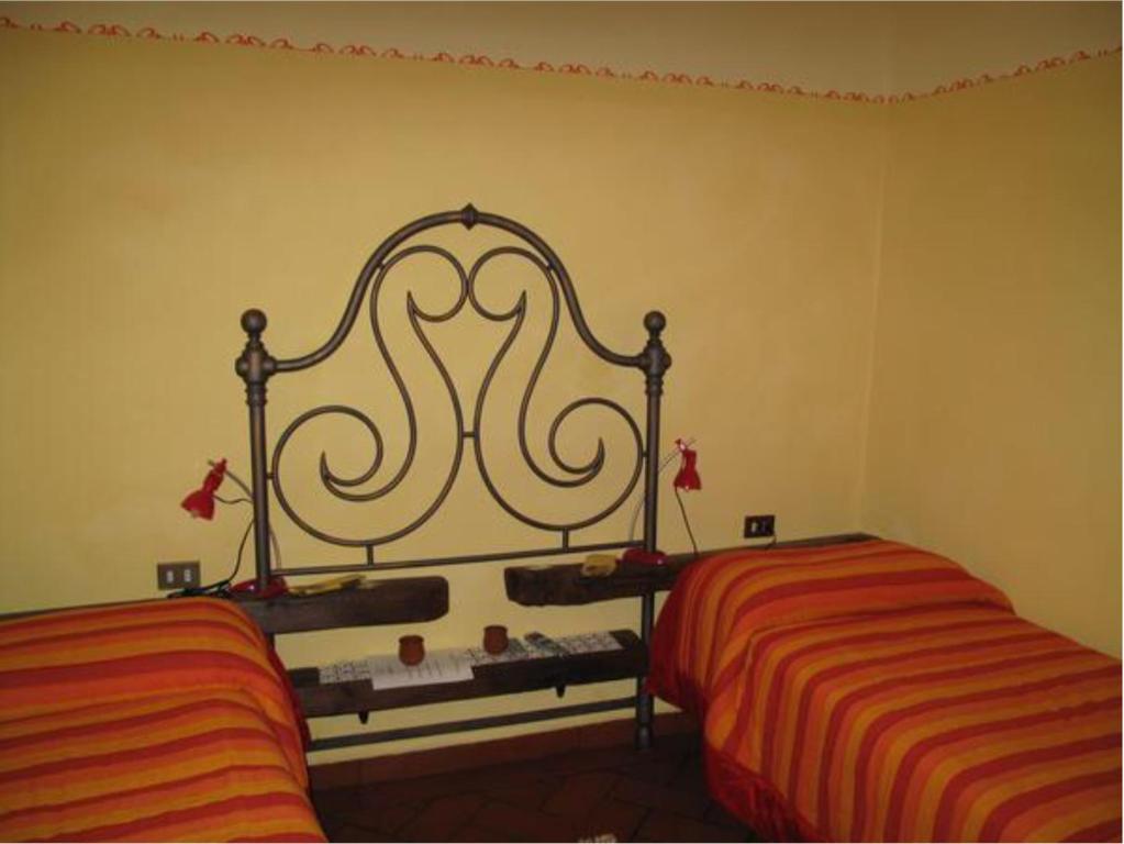 Łóżko lub łóżka w pokoju w obiekcie B&B e Locazioni Turistiche Antico Borgo Toscano