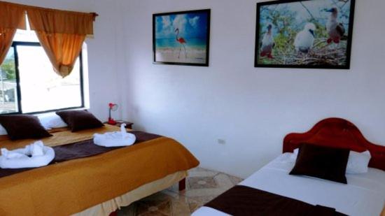 Postel nebo postele na pokoji v ubytování Hostal Sandrita