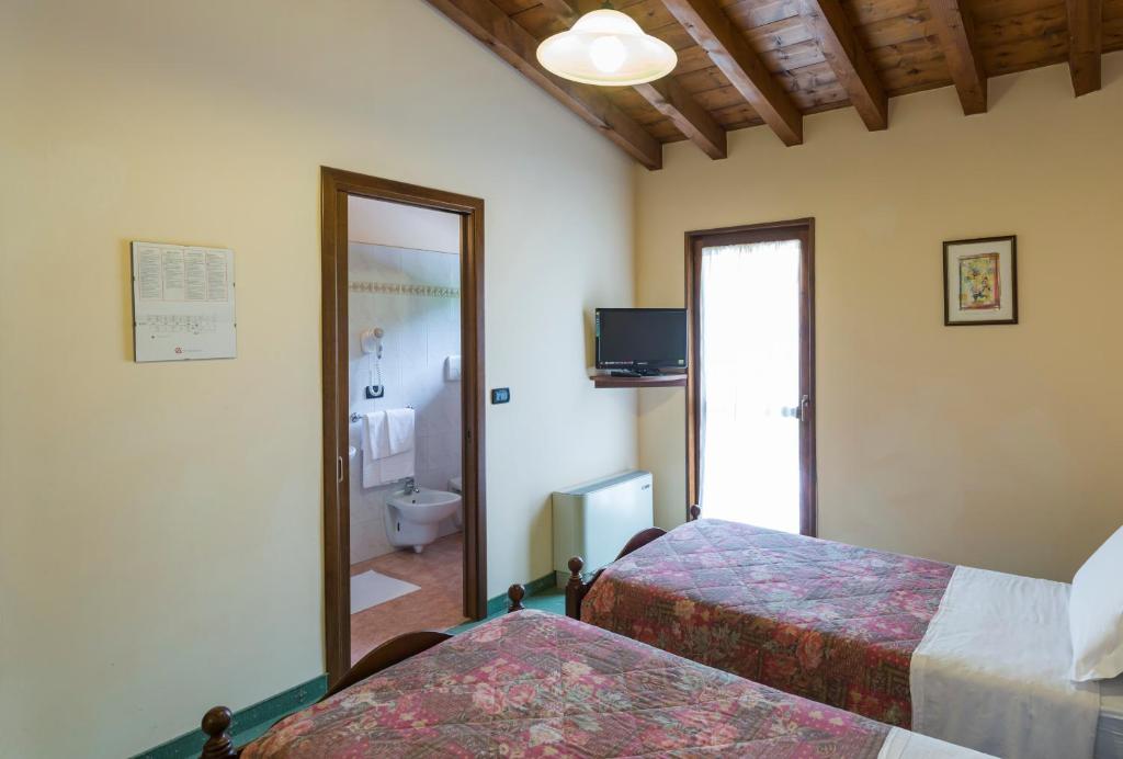 Postel nebo postele na pokoji v ubytování Hotel Conca Verde