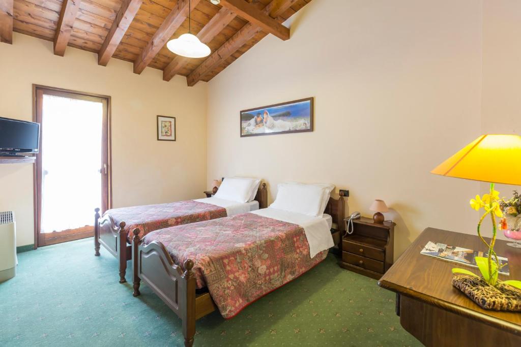 Postel nebo postele na pokoji v ubytování Hotel Conca Verde