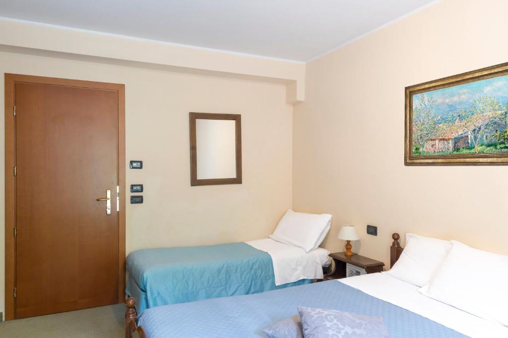 Postel nebo postele na pokoji v ubytování Hotel Conca Verde