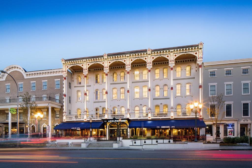 a large building with a clock on the front of it at The Adelphi Hotel in Saratoga Springs