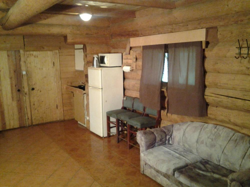 a living room with a couch and a refrigerator at Huntingbox in Purila