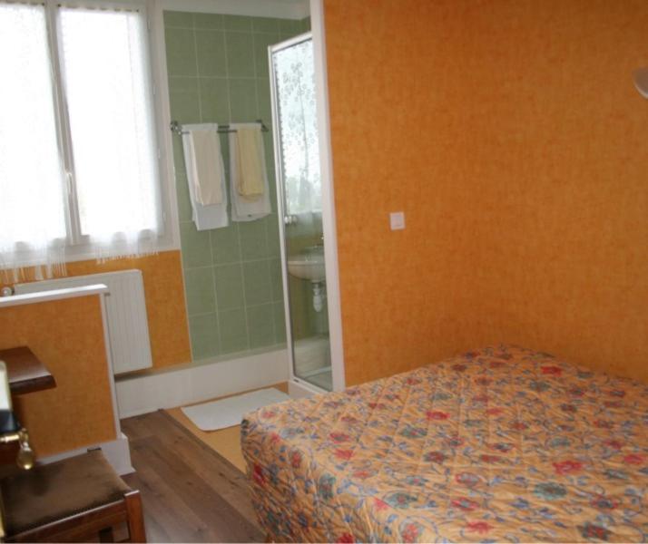 sypialnia z łóżkiem oraz łazienka z lustrem w obiekcie Aux Quatre Vents w mieście Saulieu