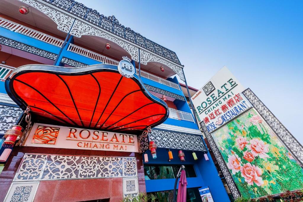 a building with a red sign on the side of it at Roseate Chiang Mai in Chiang Mai