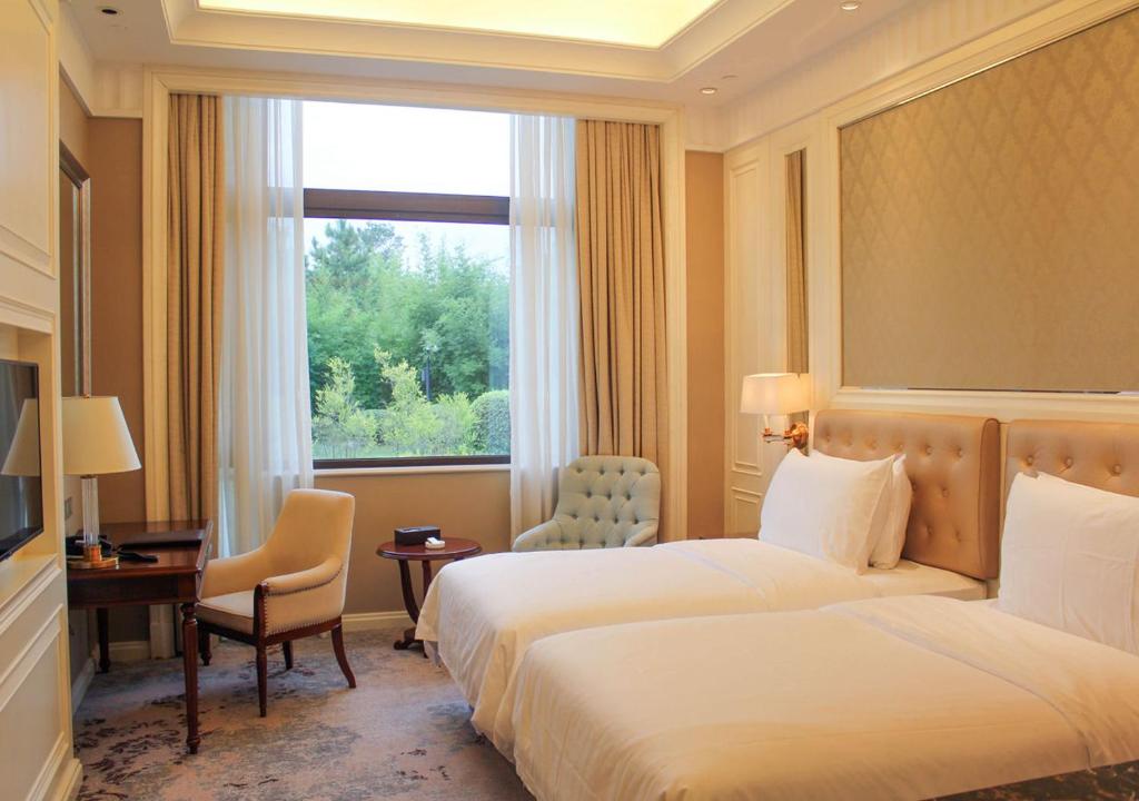 Postel nebo postele na pokoji v ubytování Carp Islet Resort Fuzhou