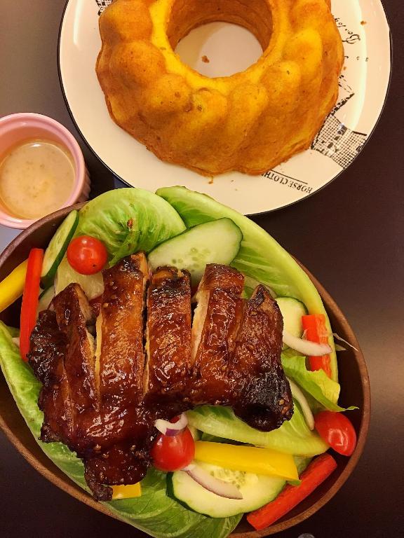 a bowl of food with meat and vegetables on a table at Spa Spring Resort in Taipei