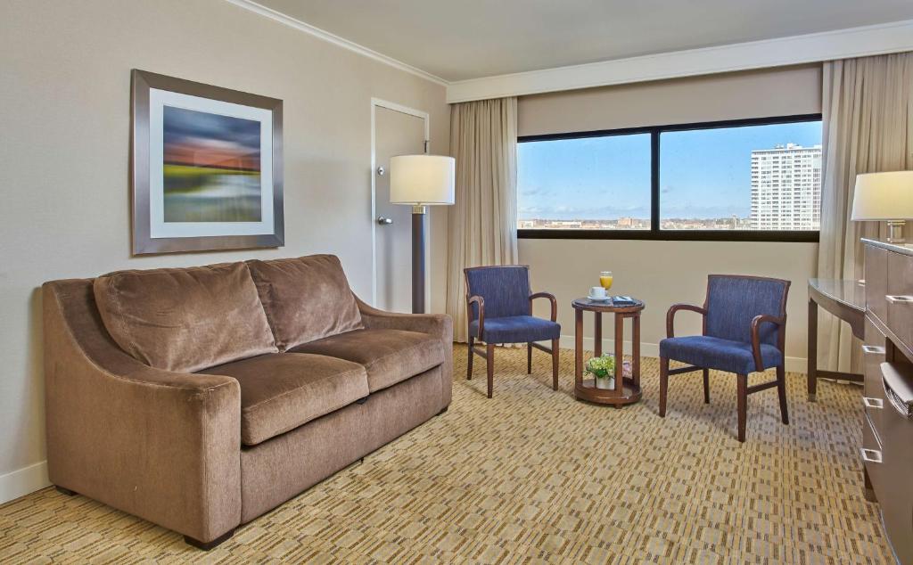 a living room with a couch and two chairs at Hyatt Regency Milwaukee in Milwaukee