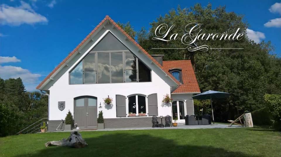 a white house with a large window at La Garonde in Berthen