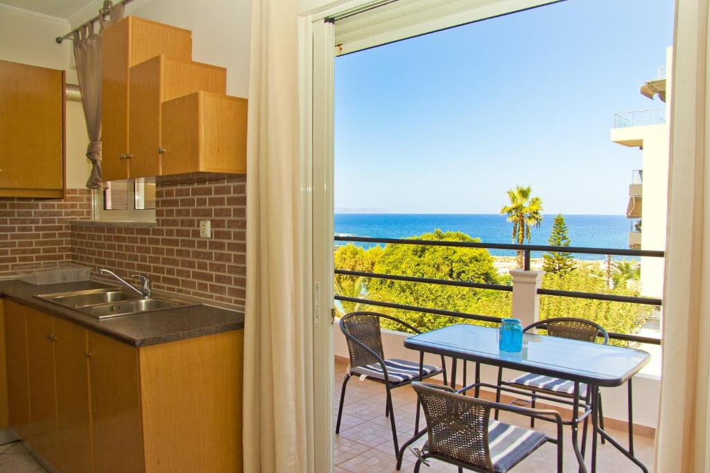 a kitchen with a table and a view of the ocean at Alkyonida Apartments in Chania Town