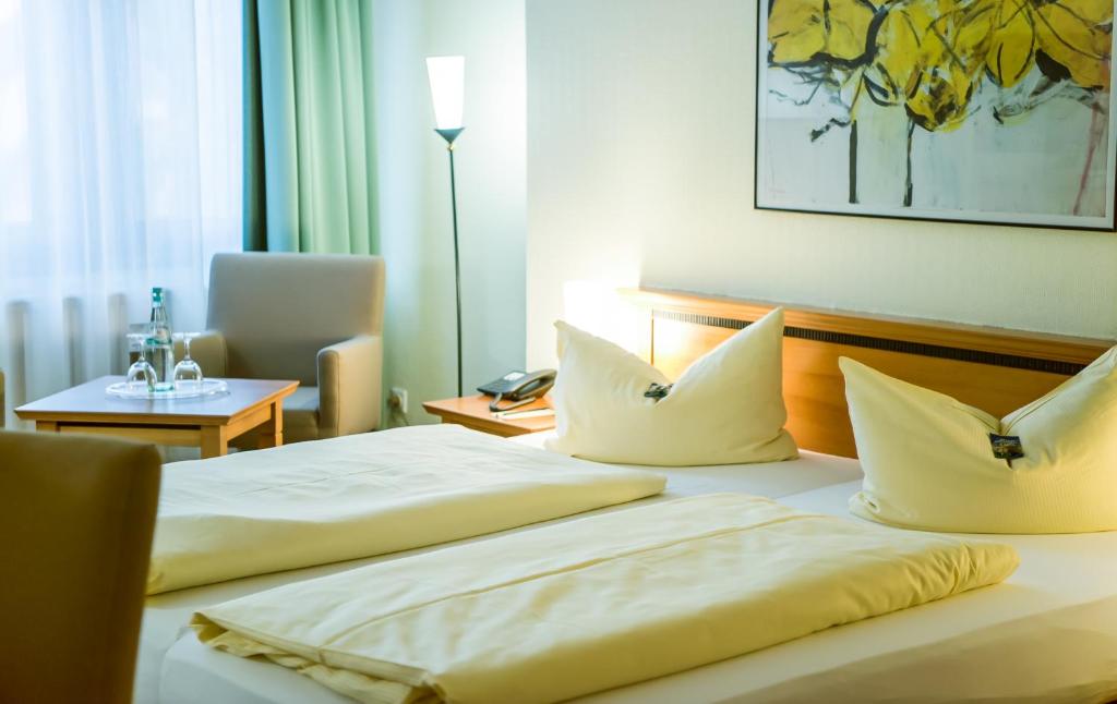 Postel nebo postele na pokoji v ubytování Ringhotel Dreiländereck Zittau