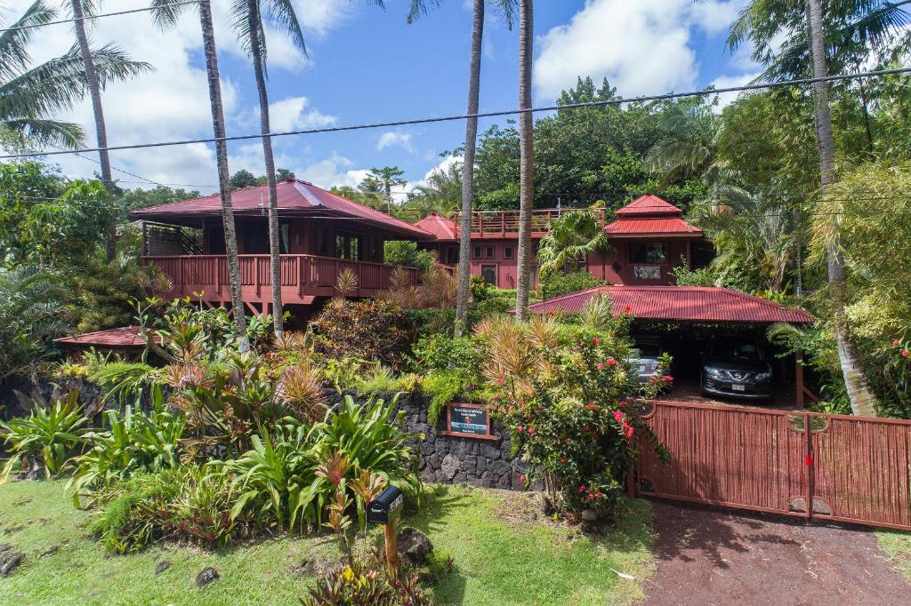 a house in the middle of a garden at The Bali House and Cottage at Kehena Beach Hawaii in Kehena