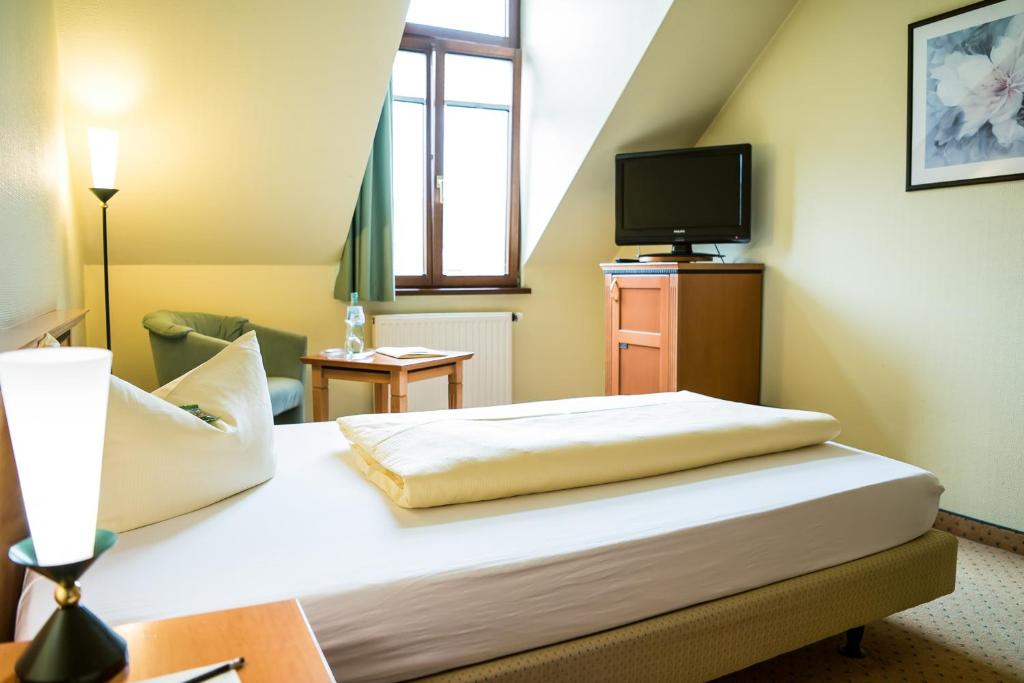 Postel nebo postele na pokoji v ubytování Ringhotel Dreiländereck Zittau