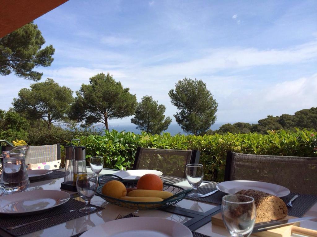a table with a bowl of fruit on it with a view at Can Alison in Begur
