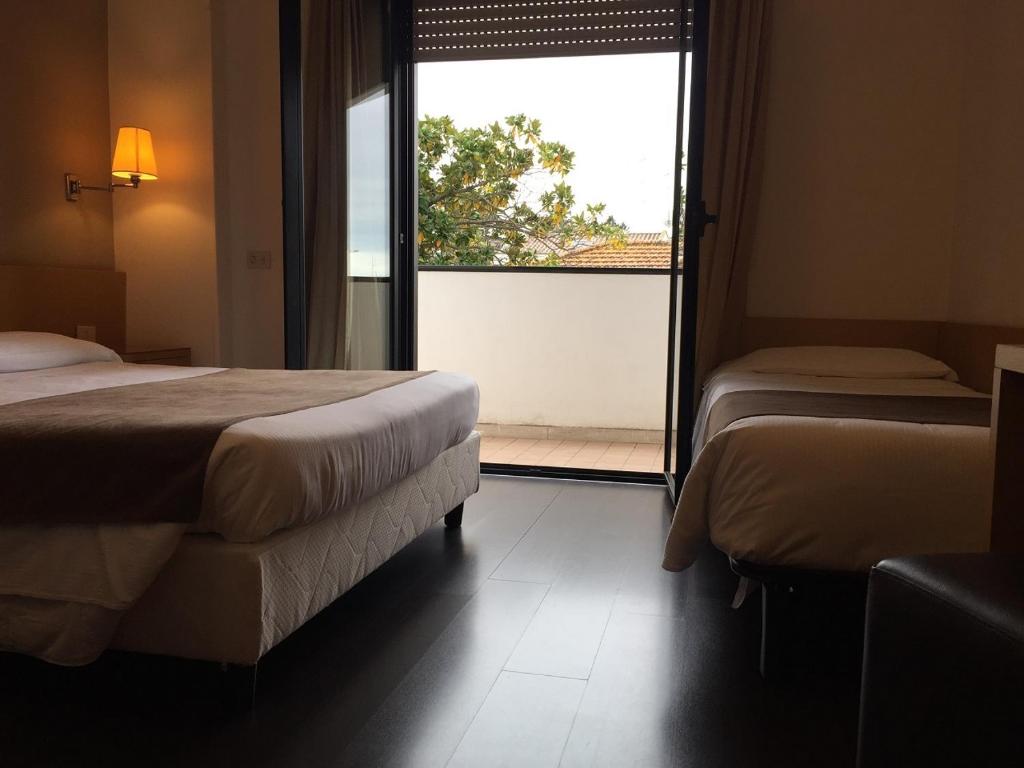 Postel nebo postele na pokoji v ubytování Hotel Sisto V
