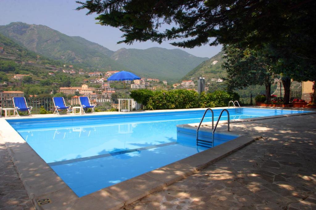 a swimming pool with a view of a mountain at Residence Le Villette in Ravello