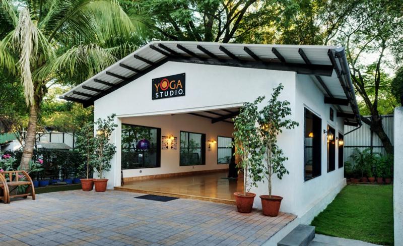 a building with a sign that reads noosa studio at Hotel Sunderban Resort & Spa in Pune