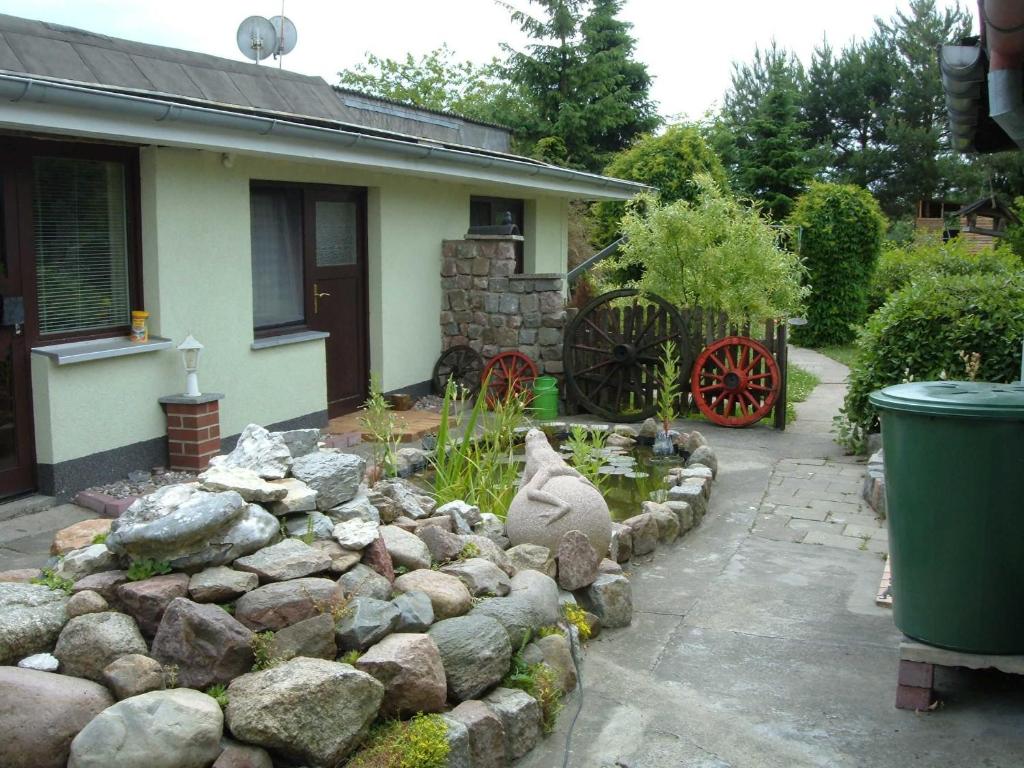 a backyard with a rock garden in front of a house at Ferienbungalow 1 in Dierkow