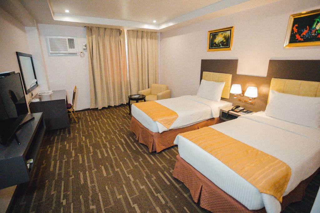 Postel nebo postele na pokoji v ubytování Butuan Grand Palace Hotel