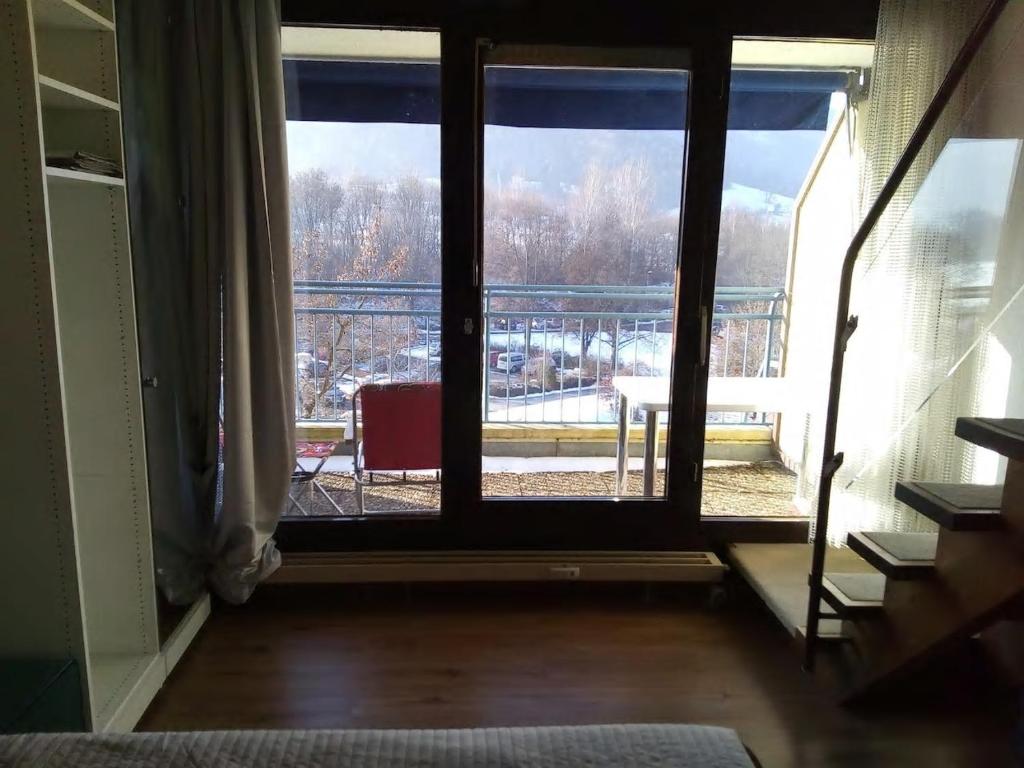 a room with a window with a view of a balcony at BaMeS BadUrach Metzingen Stuttgart in Bad Urach