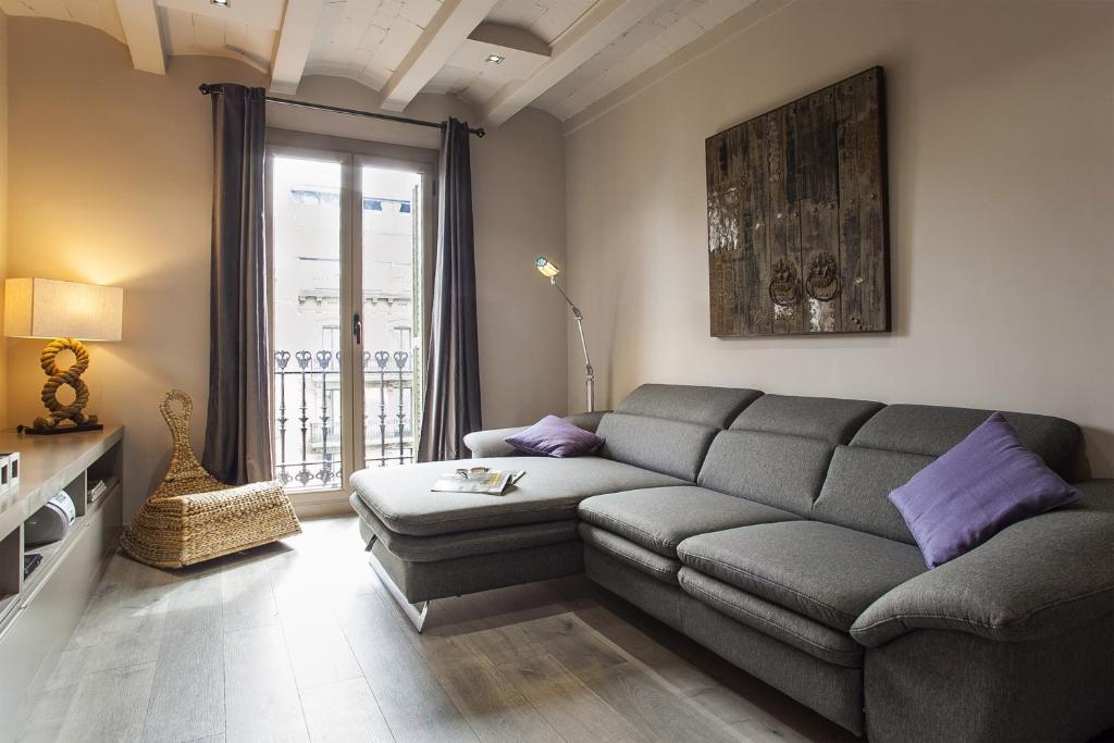 a living room with a couch and a window at Elegant Eixample Apartment nicely decorated in Barcelona