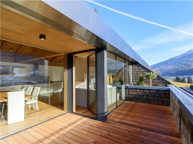 a balcony of a house with a view of the mountains at Penthouse am Sonnenhang in Neukirchen am Großvenediger