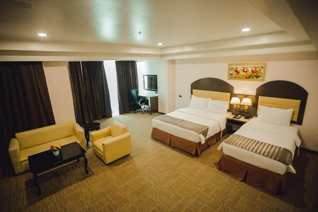 Postel nebo postele na pokoji v ubytování Butuan Grand Palace Hotel