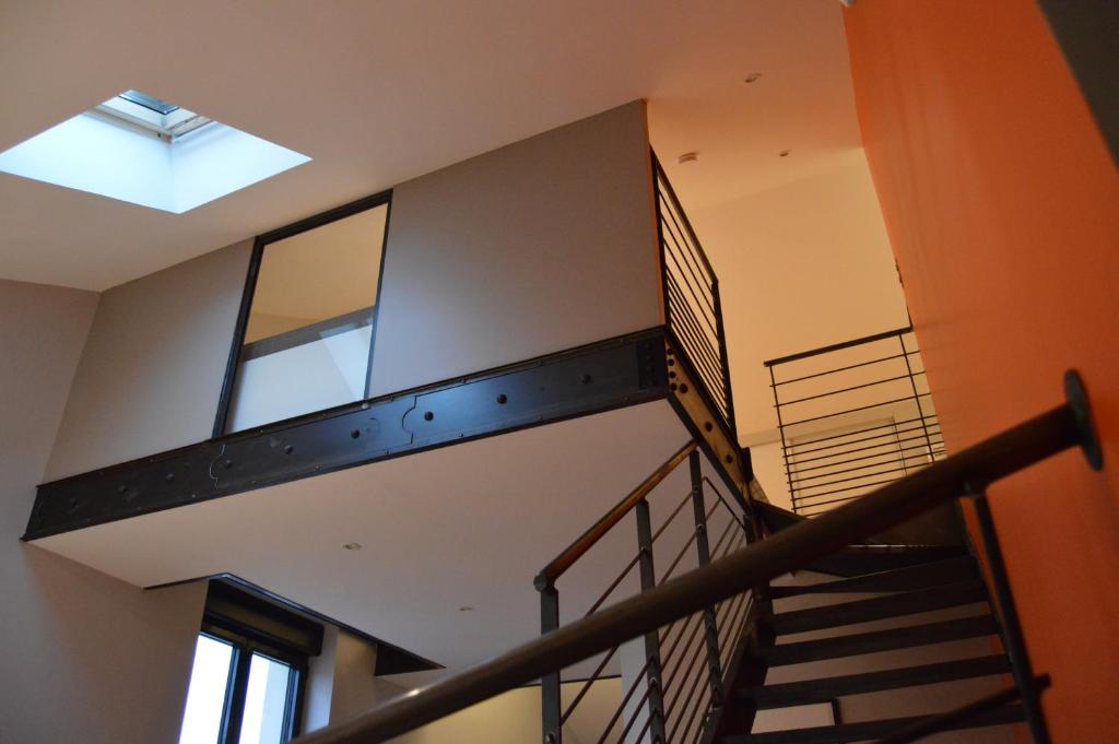 a staircase in a building with a skylight at Le Loft de Genas entre Eurexpo et St Exupéry in Genas