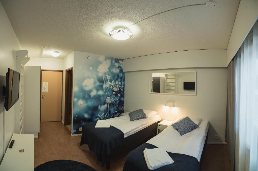 Postel nebo postele na pokoji v ubytování Hotel Kittilä