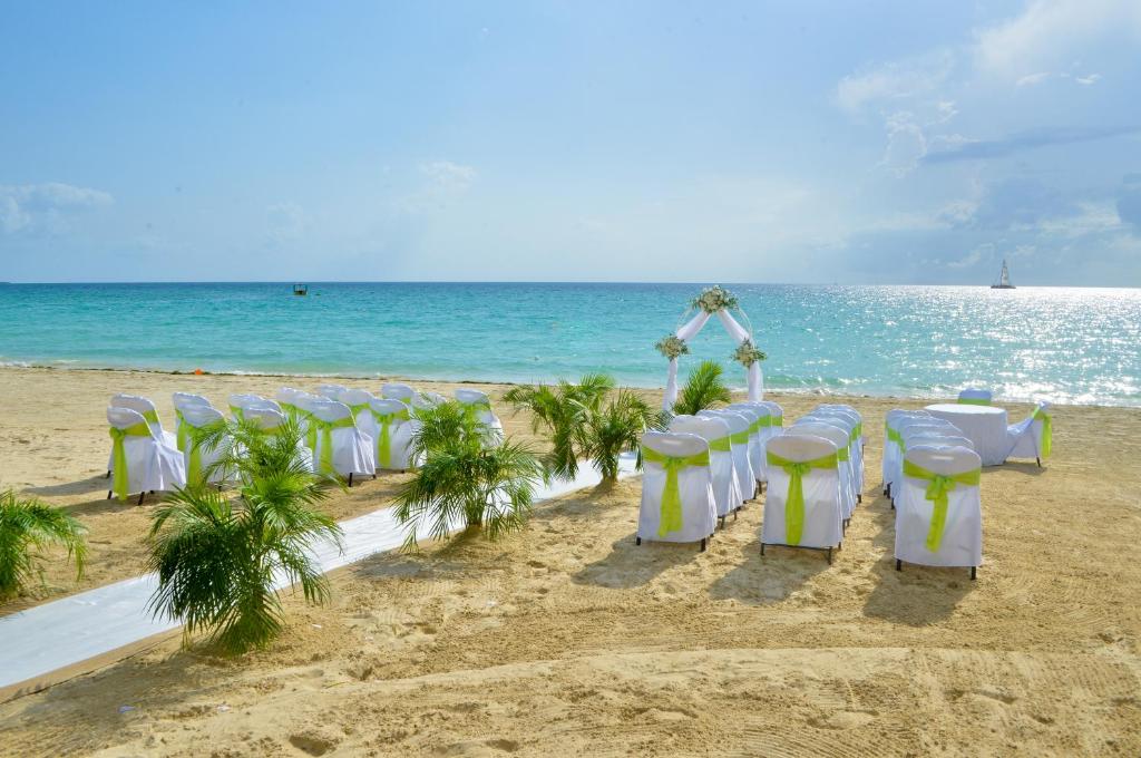 a row of tables and chairs on the beach at Coco La Palm in Negril