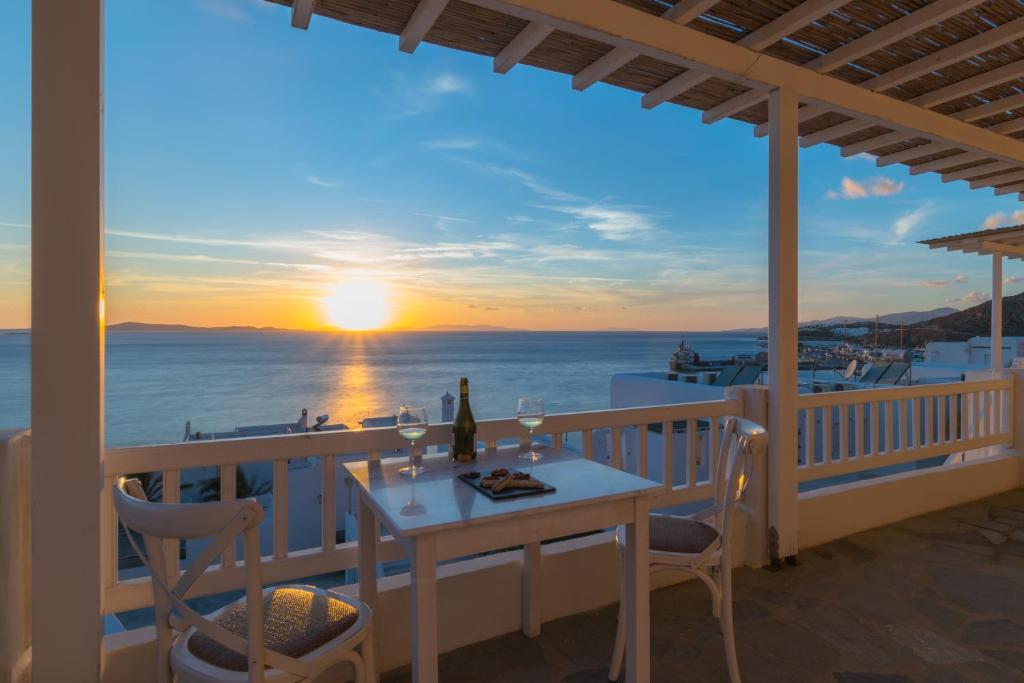 a dining room table with a view of the ocean at With-inn in Tourlos