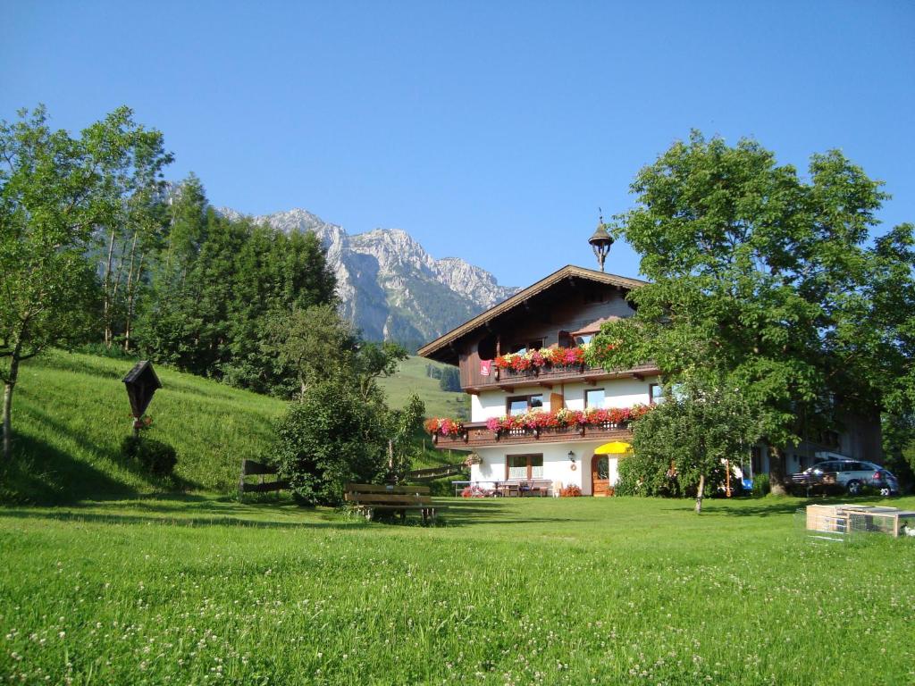 a house with flowers on the roof in a field at Jagerhof in Walchsee