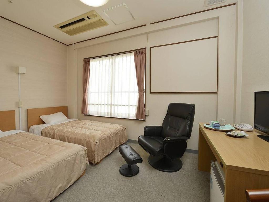 Postel nebo postele na pokoji v ubytování Itoen Hotel Matsukawakan