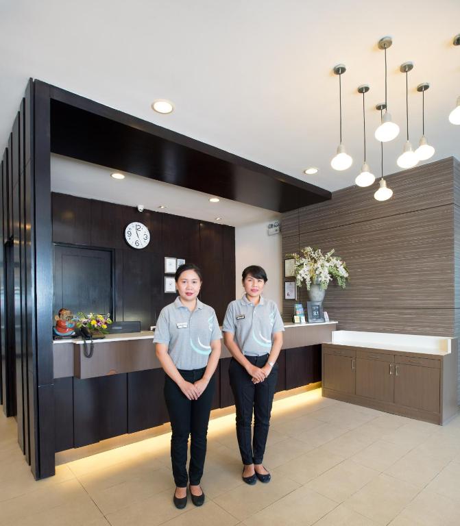 two people standing in the lobby of a hotel at Simplitel in Karon Beach