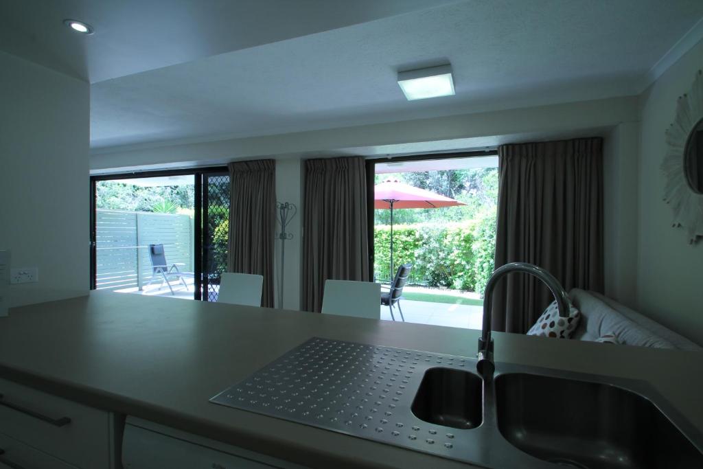 a kitchen with a table with a laptop on it at La Mer Holiday Apartments in Mooloolaba