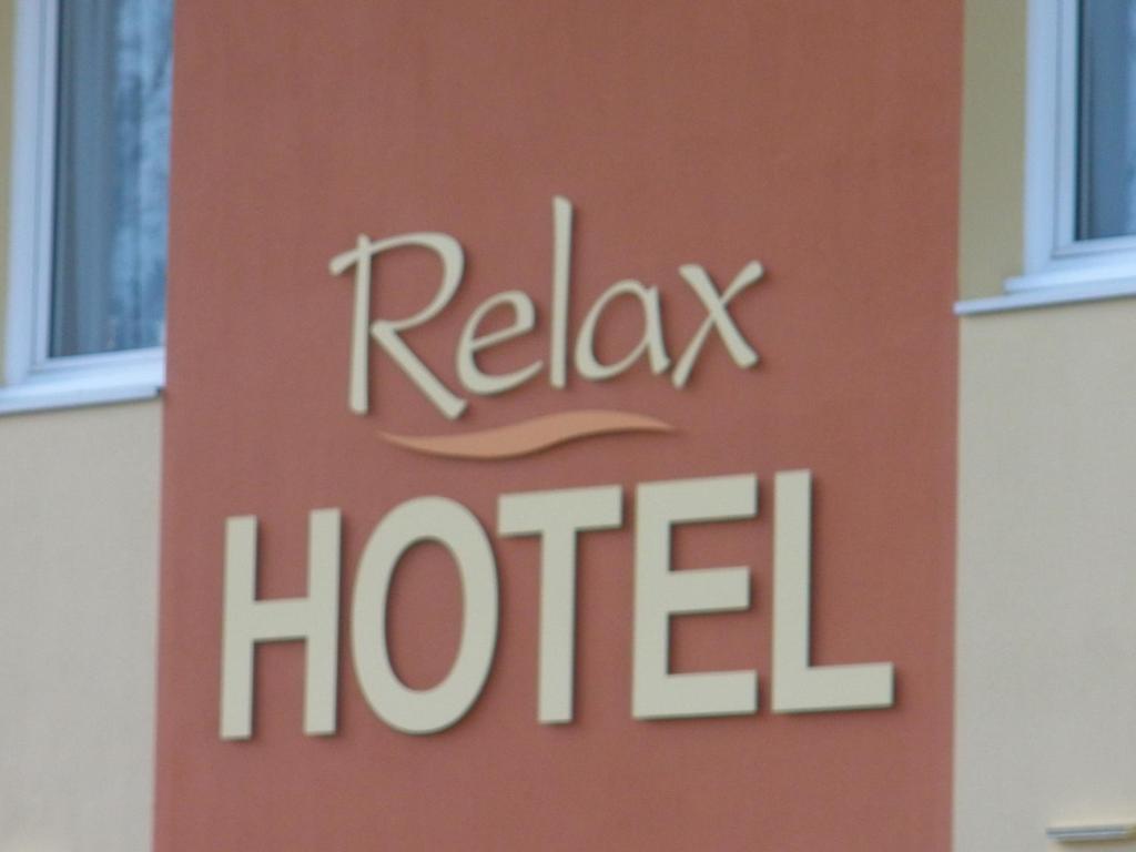 a hotel sign on the side of a building at Relax Hotel in Maillat
