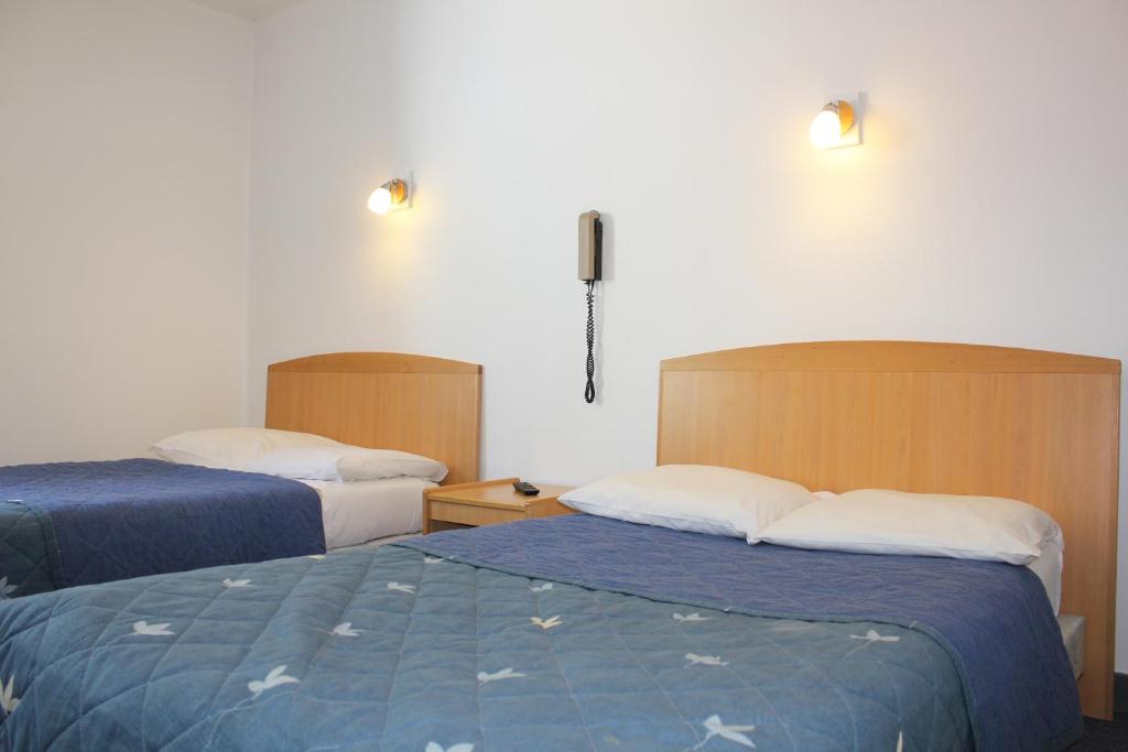 Postel nebo postele na pokoji v ubytování Hotel Le Chapitre