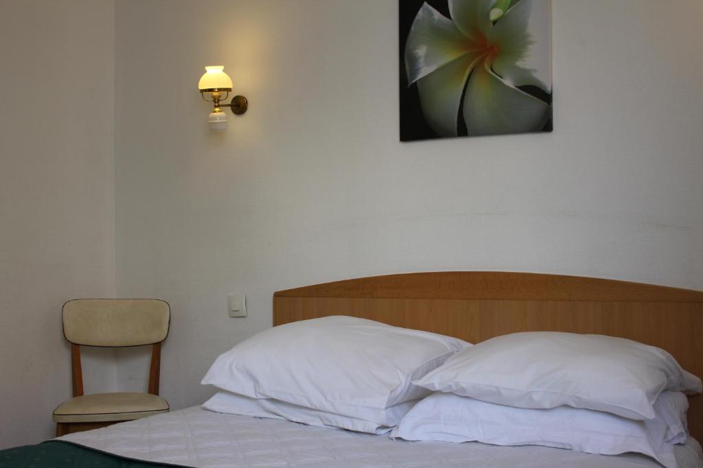 Postel nebo postele na pokoji v ubytování Hotel Le Chapitre
