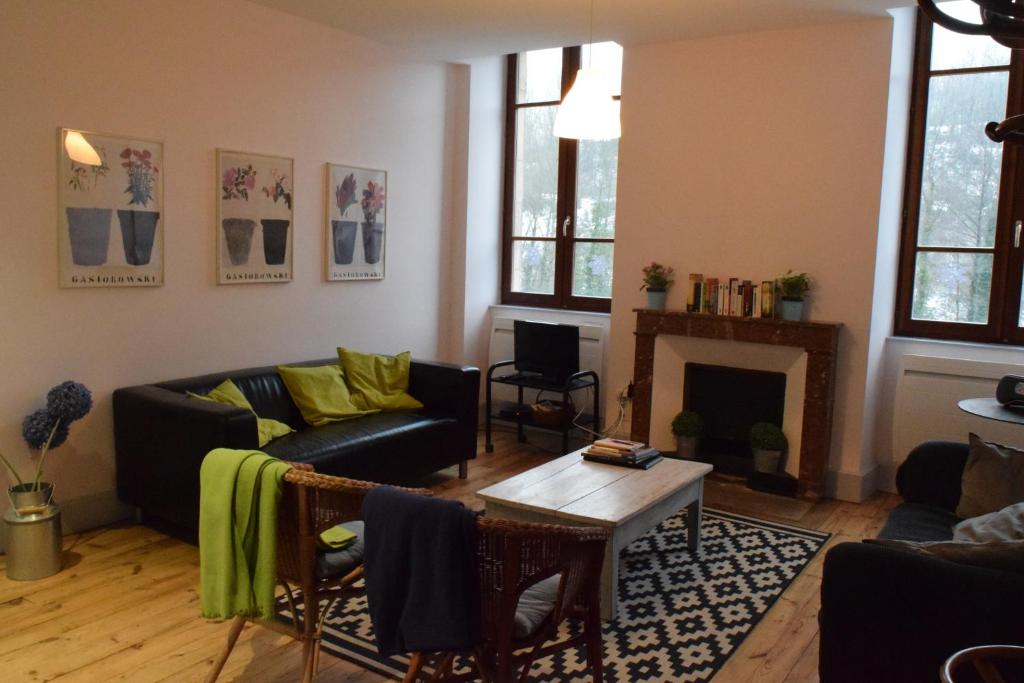 a living room with a couch and a fireplace at Chez Marie in Pont-en-Royans