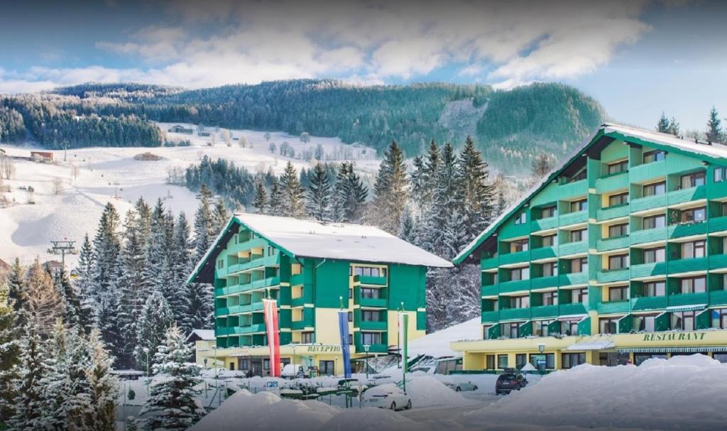 a hotel in the mountains with snow on the ground at Alpine Club by Schladming-Appartements in Schladming