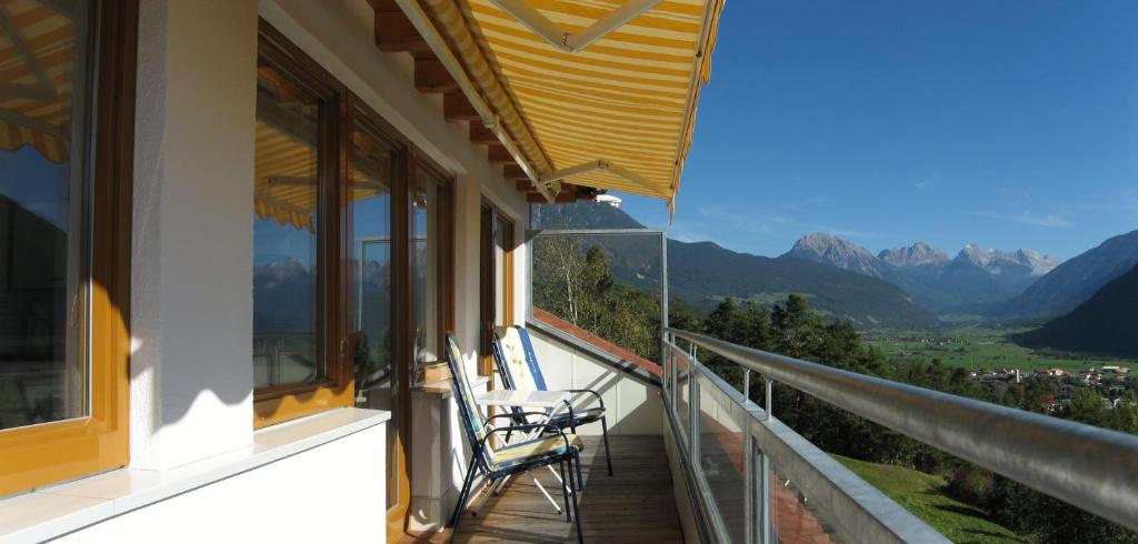 a balcony with chairs and a view of mountains at Am Zanggerhof in Imst