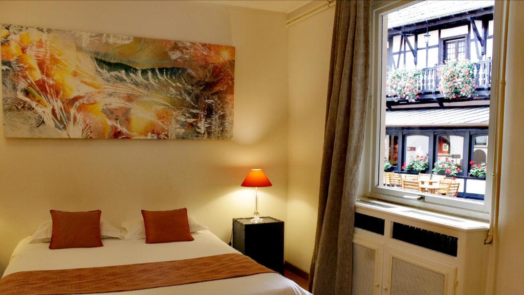 Postel nebo postele na pokoji v ubytování Le Gouverneur Hotel