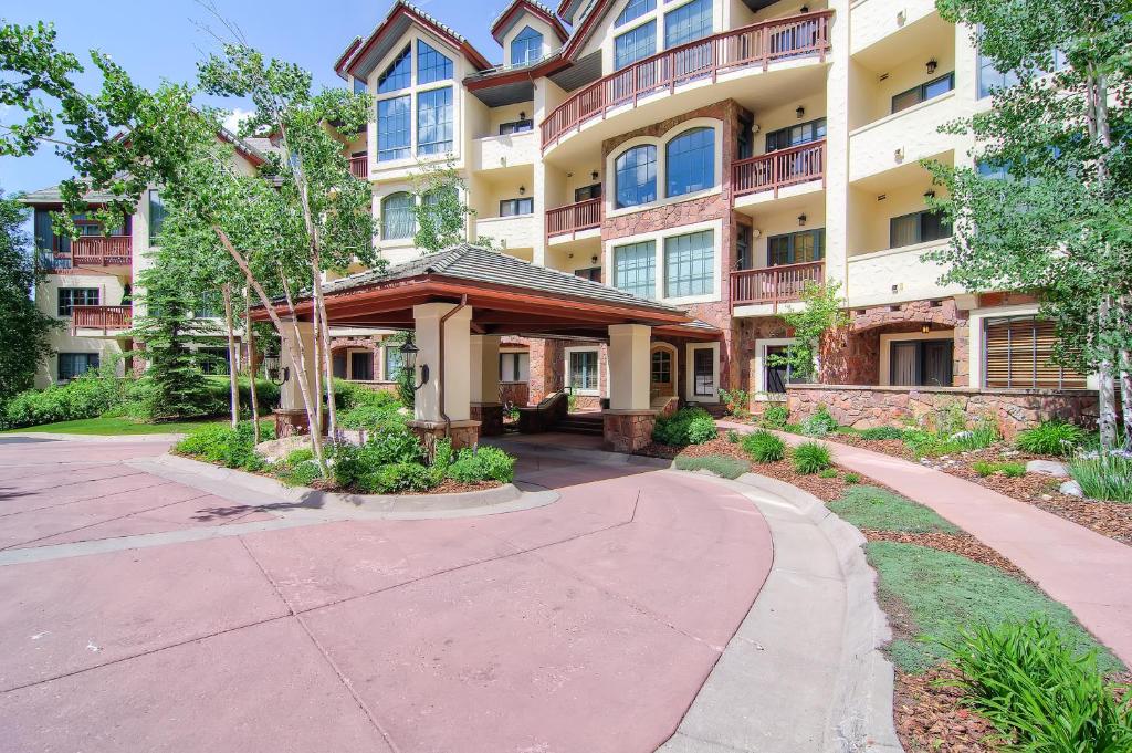 an apartment building with a walkway in front of it at Oxford Court by East West Hospitality in Beaver Creek